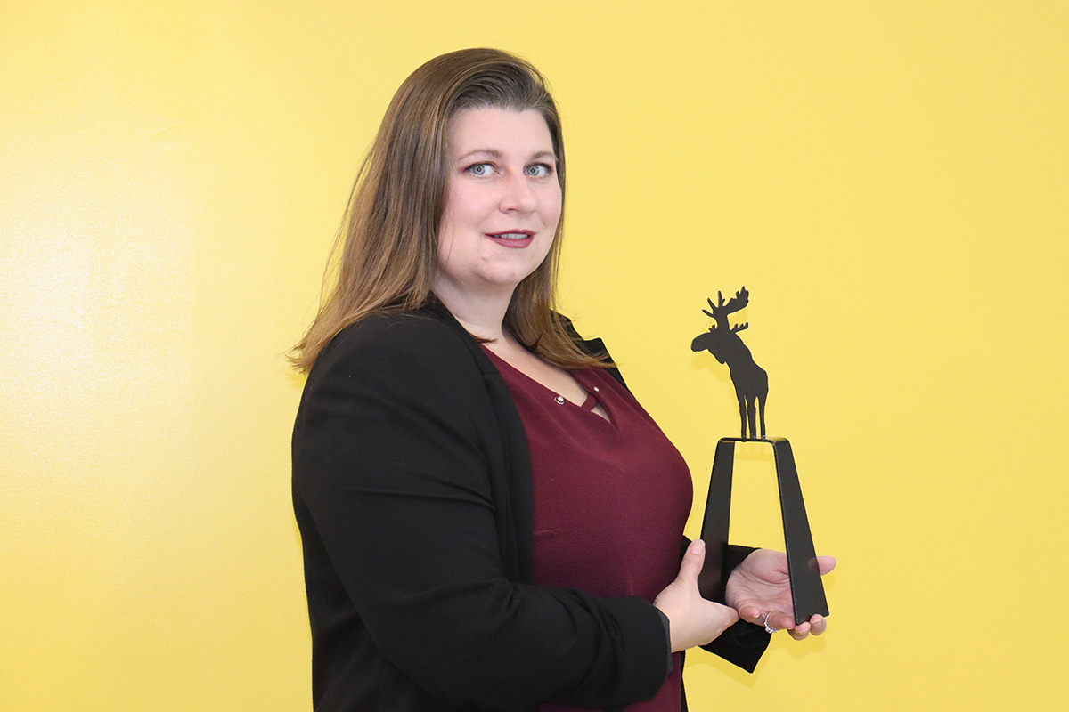 Lady holding a trophy.