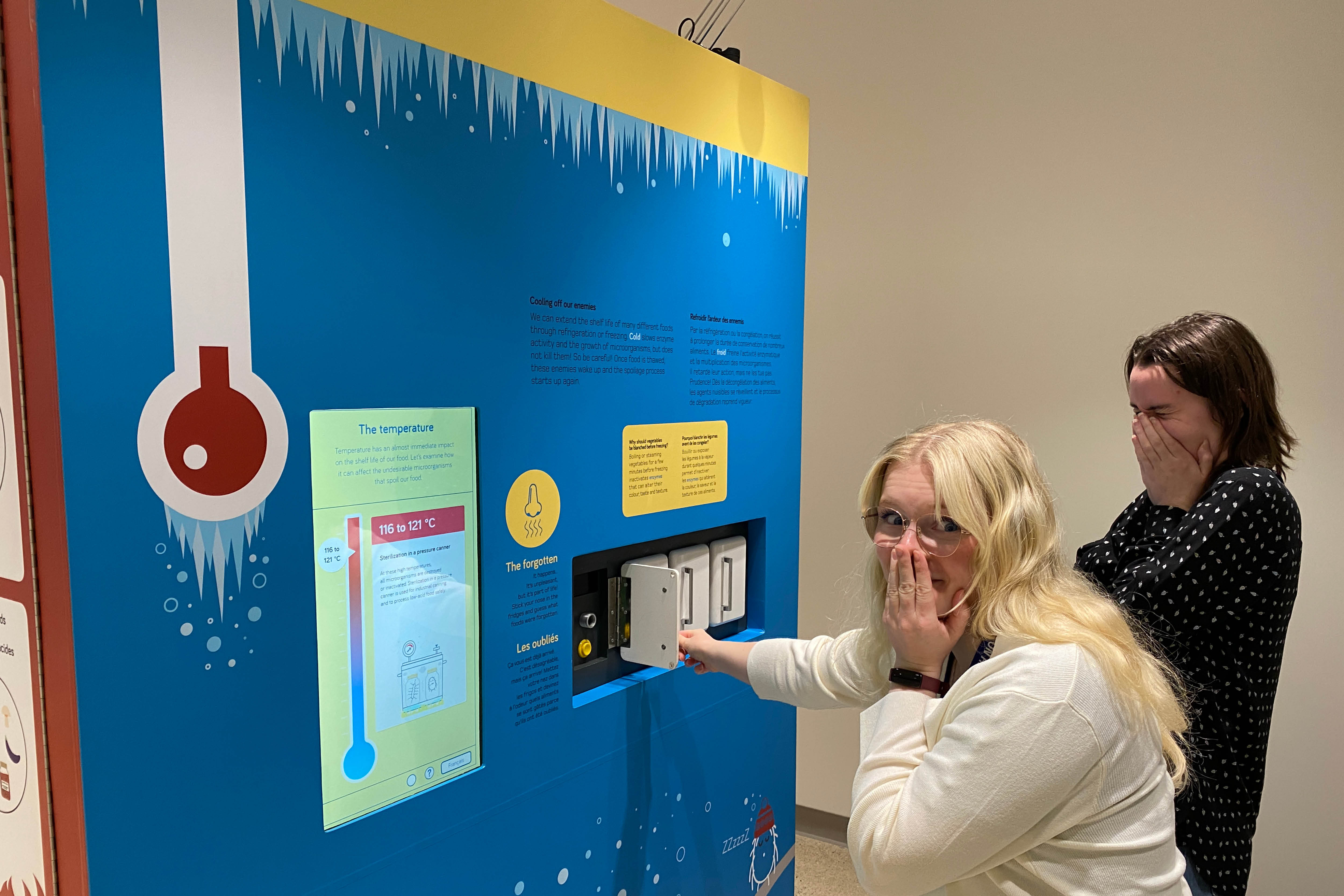 Staff try out an interactive display in A Taste of Science that invites visitors to identify foods ‘forgotten’ in the fridge by scent.