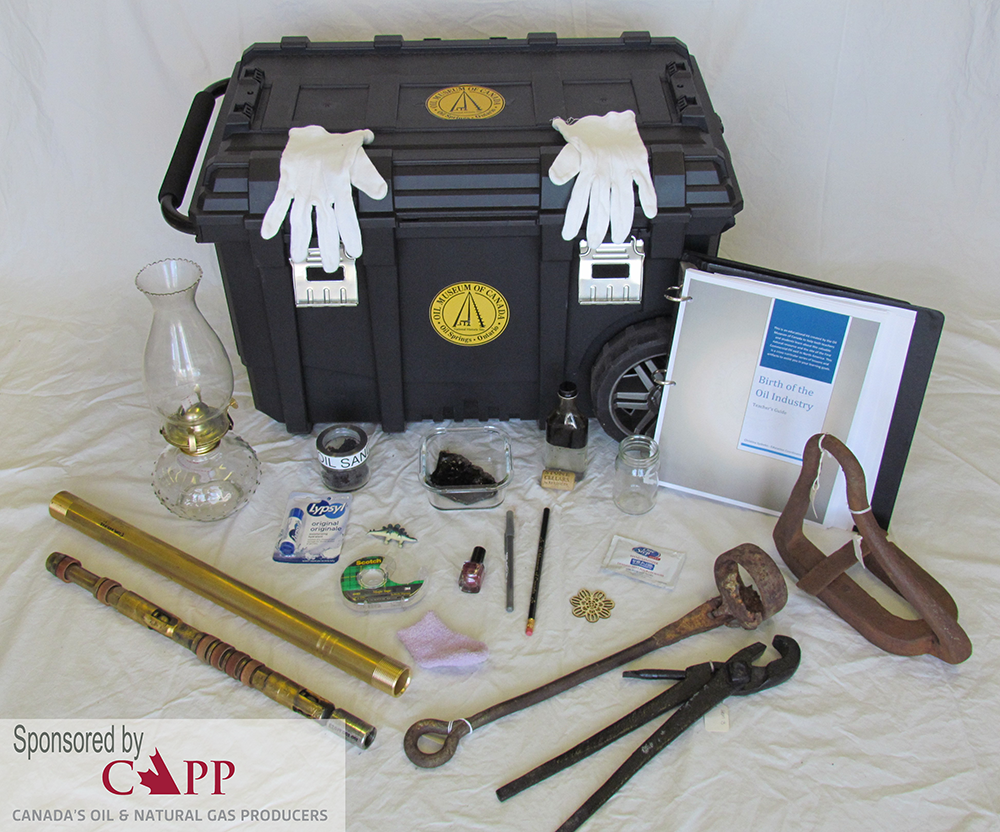 White gloves on a black container with artifacts surrounding it.