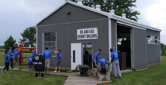 Volunteers outside the oil and gas exhibit building at OMC.