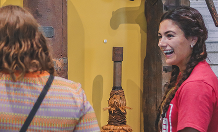 women smiling at a visitor, engaging in conversation.