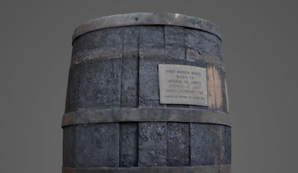A dark wooden barrel with a plaque on it. 