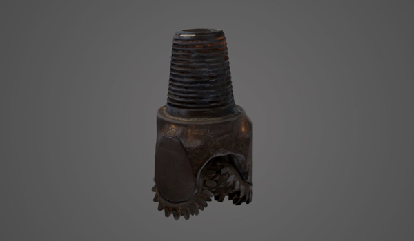 A large, brown metal drill bit.