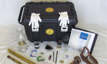 Black case with white gloves and artifacts around it.