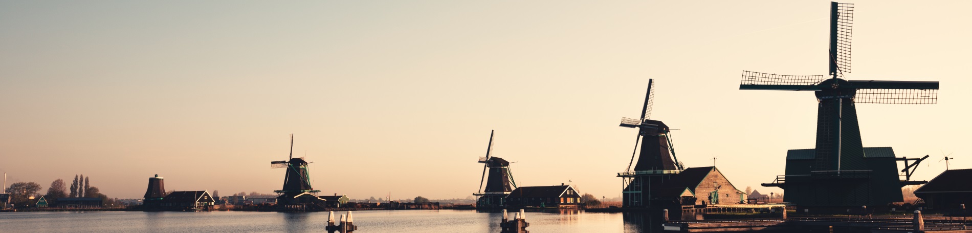 waterfront with windmills and buildings